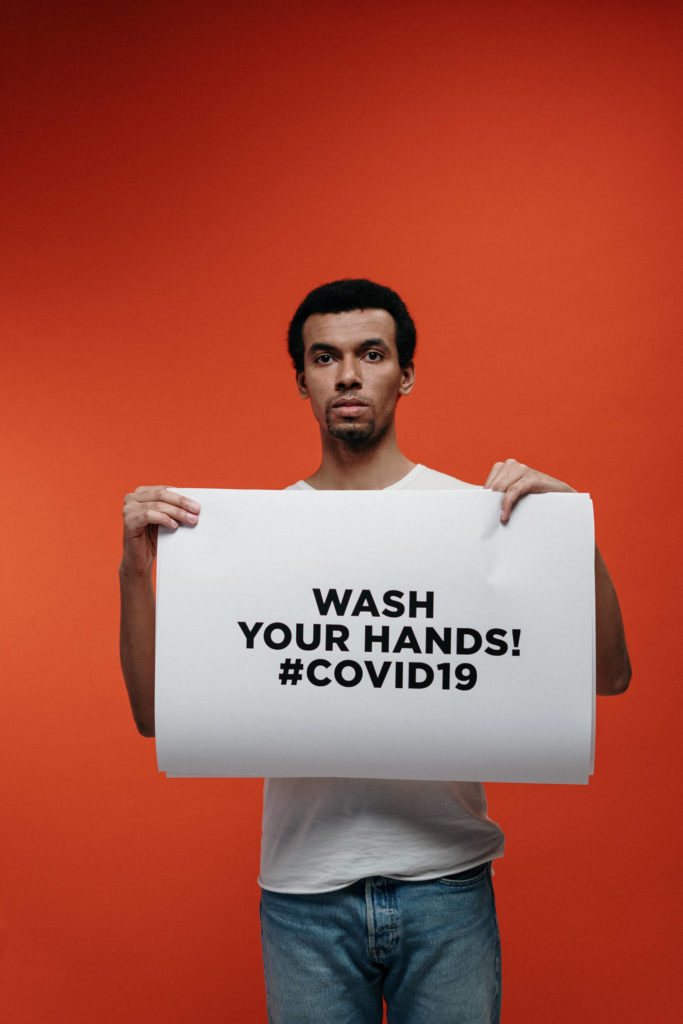 Man Holding A Sign For Guidance Against Coronavirus 3952194 683x1024