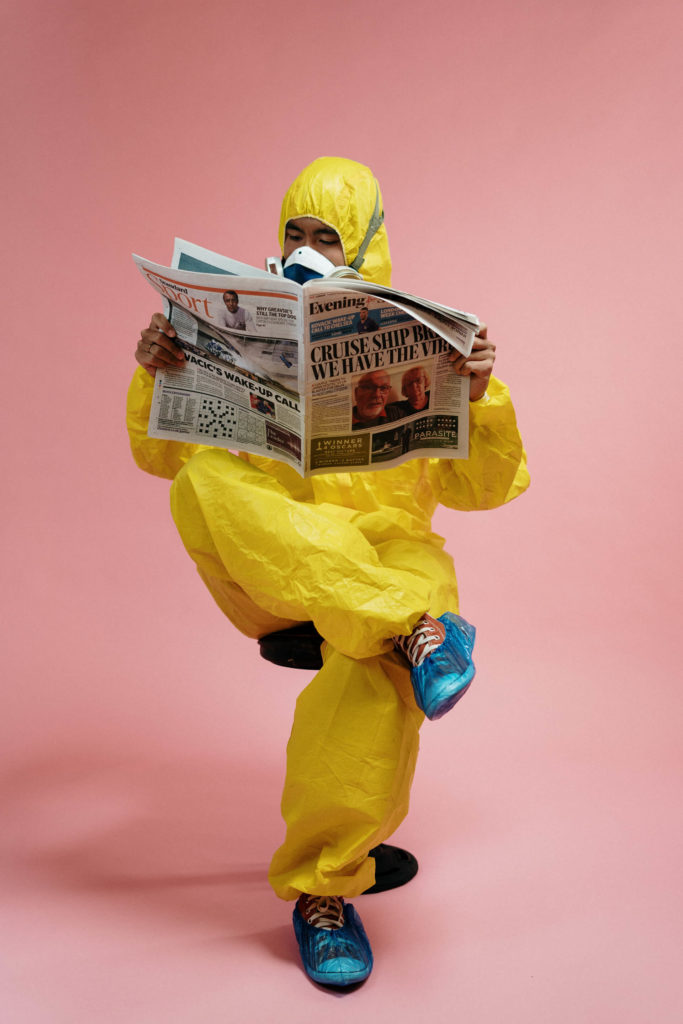 Man In Yellow Protective Suit Holding A Newspaper 3951350 683x1024